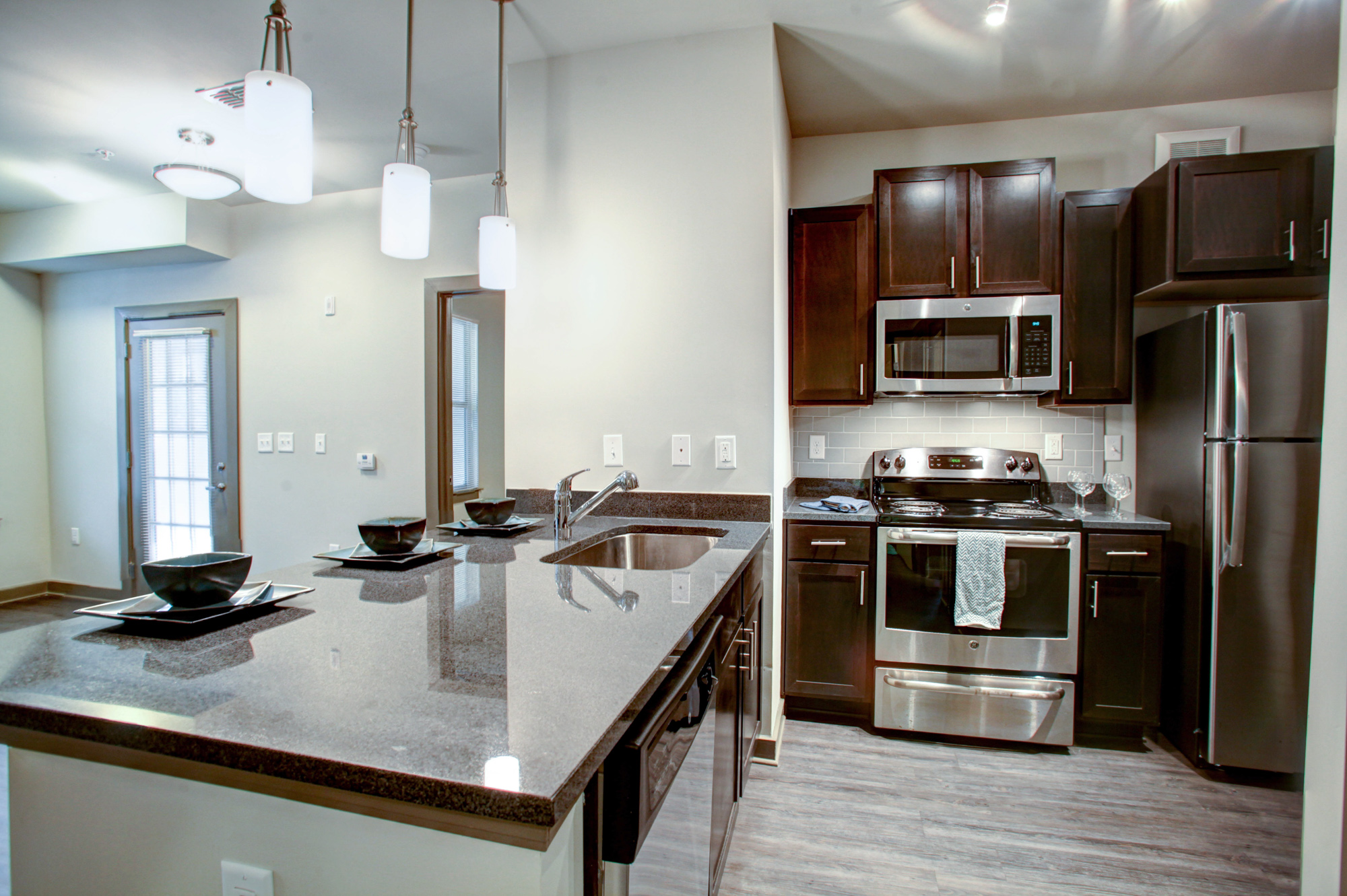 On the left is a kitchen island and on the right are stainless steel appliances at Park 9 apartments near Atlanta, GA.