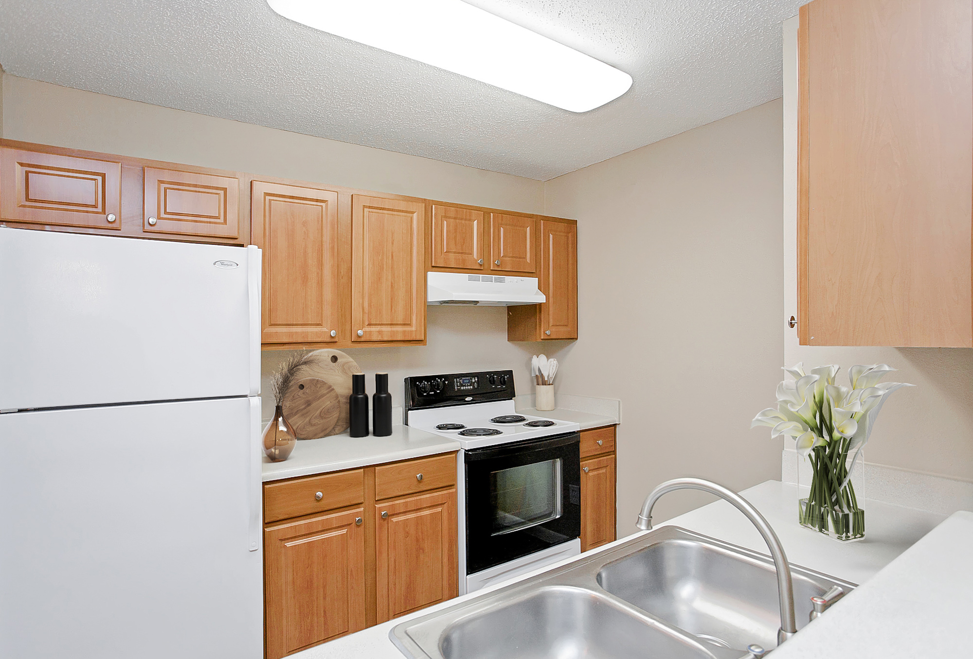 The kitchen of an apartment at The Arbors of Wells Branch in Austin, TX.