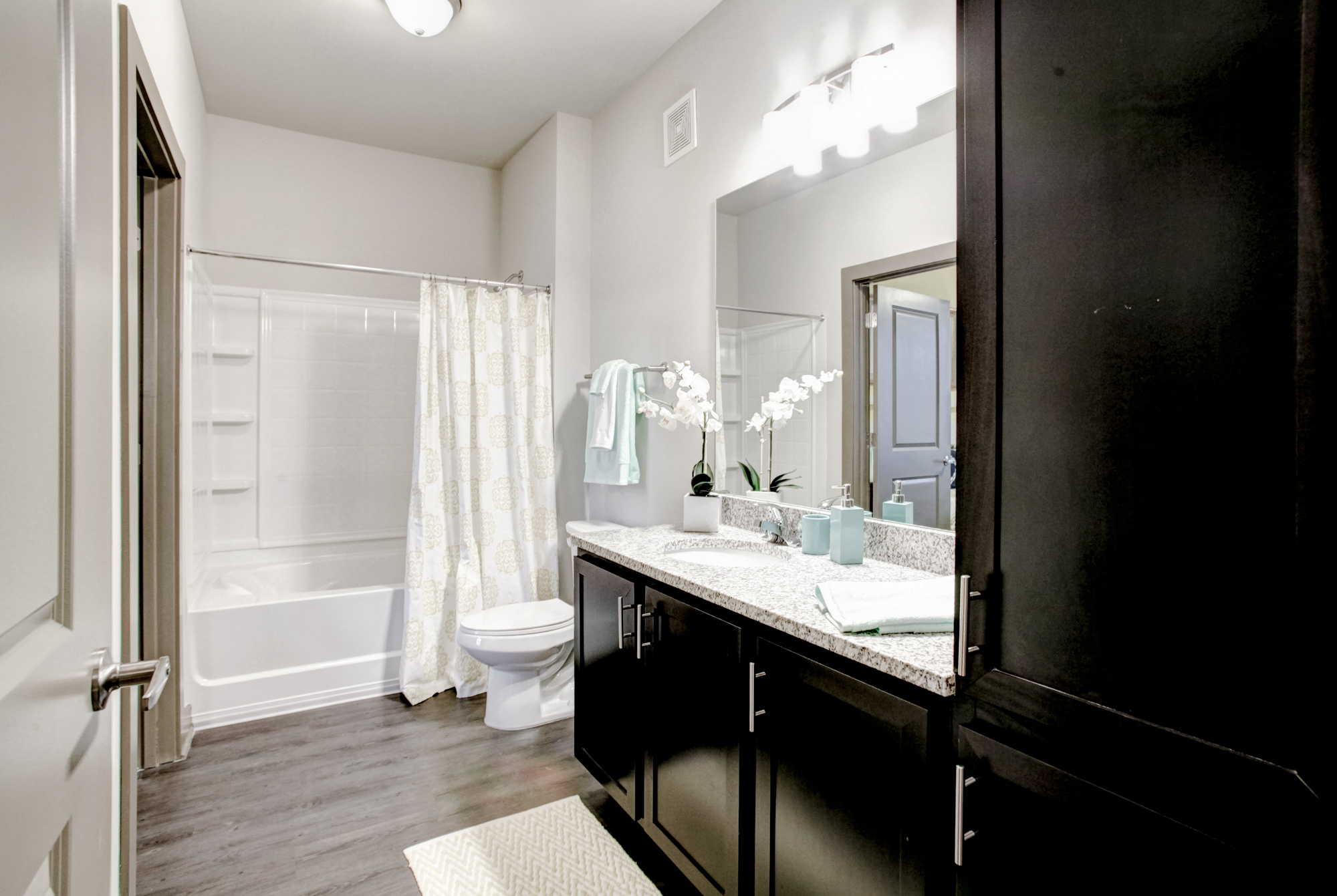 Bright, white features are complimented by dark cabinetry in the bathrooms at Park 9.