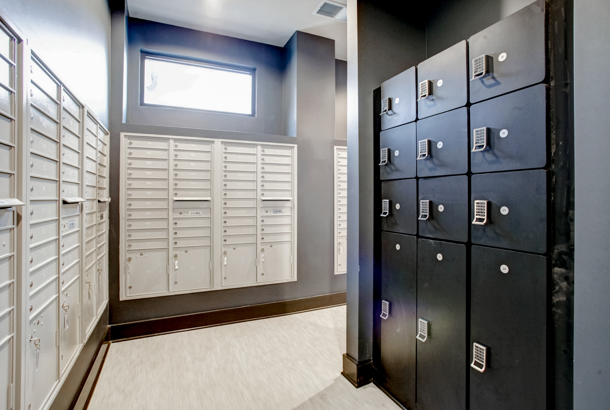 A mail room filled with mail boxes and parcel storage on the right at Park 9 apartments.