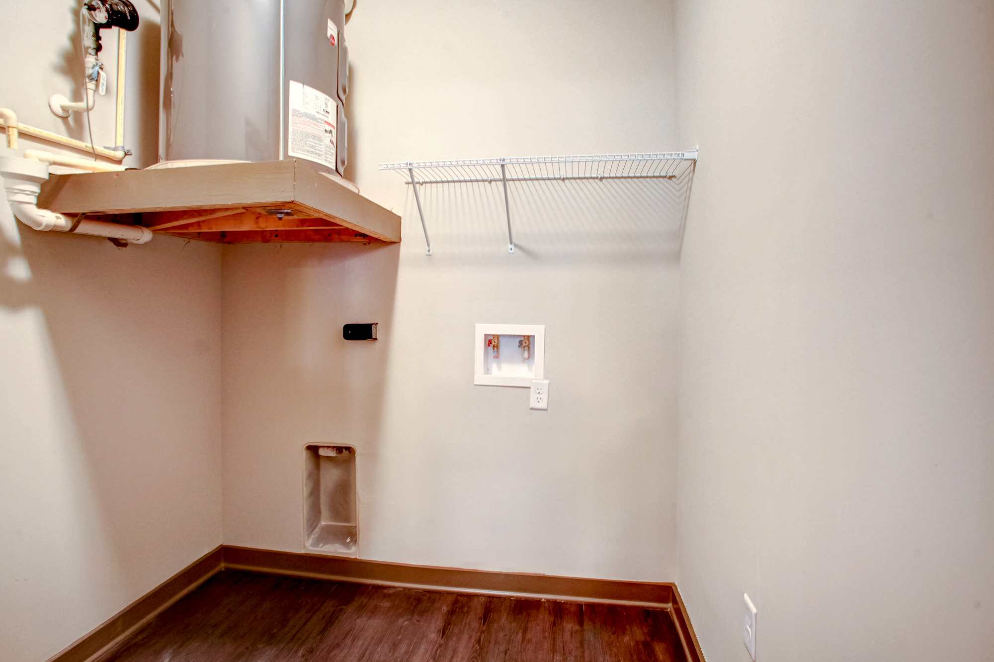 A spacious closet with washer and dryer connection.