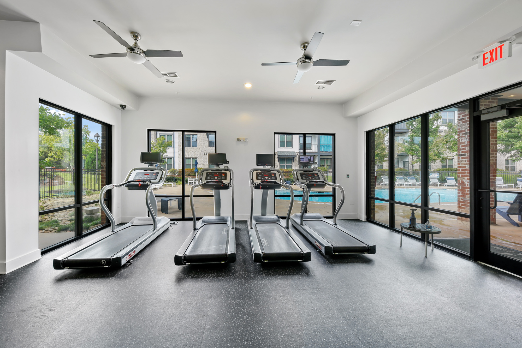 Four treadmills look out to a pool deck at Park 9 apartments in Woodstock, GA.