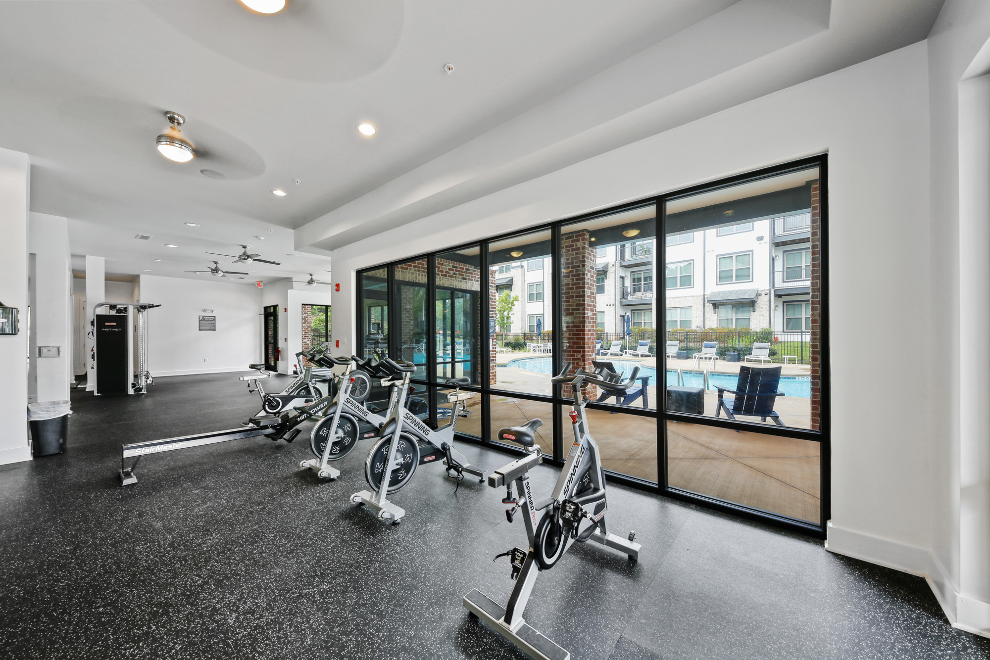 Cardio equipment at Park 9 apartments near Atlanta looks out to the pool deck.